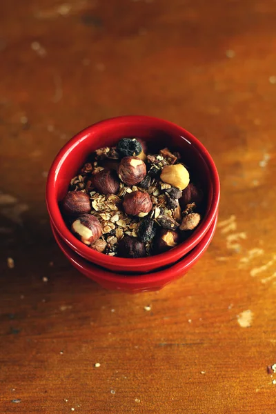 Organic granola with toasted oats, roasted hazelnuts, dates, raisin and dried figs in a jar for healthy breakfast or snack