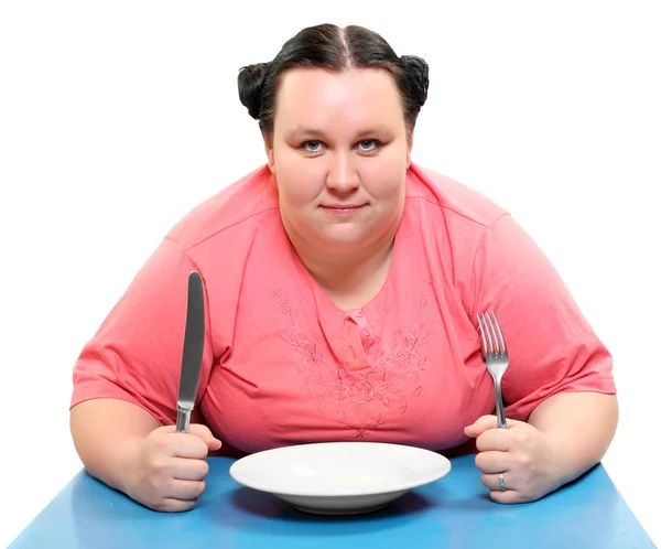 Hungry obese woman with empty plate. Funny picture on diet theme.