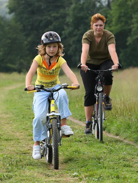 Mother and daughter bicycle riding