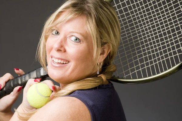 Woman practicing tennis stroke