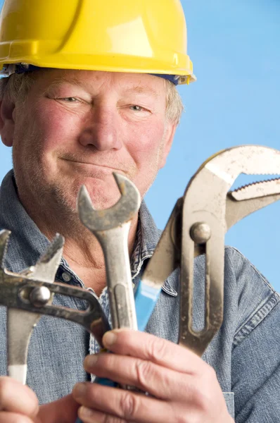 Smiling happy contractor builder with tools