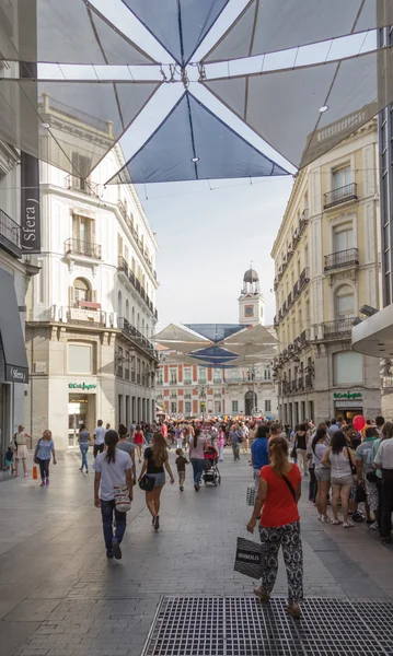 People walking on Preciados street, in Madrid, Spain