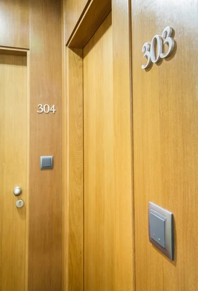 Door closed with electronic key and room number in hotel