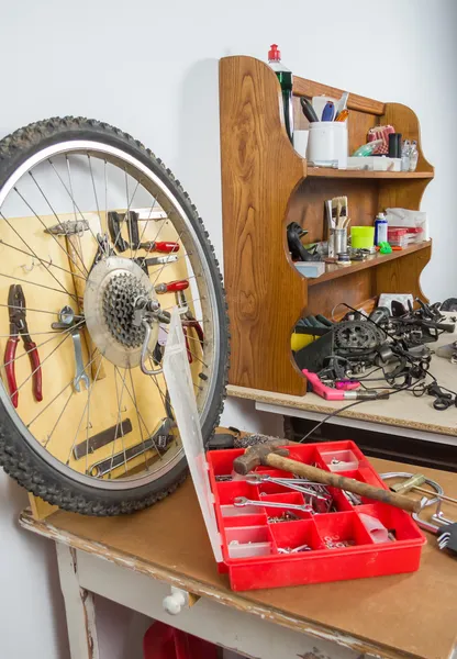 Wheels and bicycle parts over workshop table