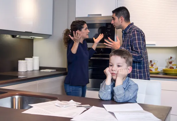 Sad child suffering and parents having discussion