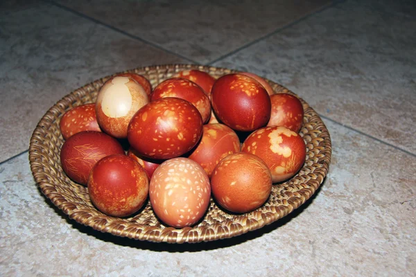 Naturally painted Easter eggs arranged in braided basket