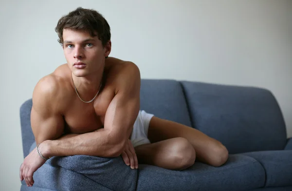 Young Sexy Man on a Sofa