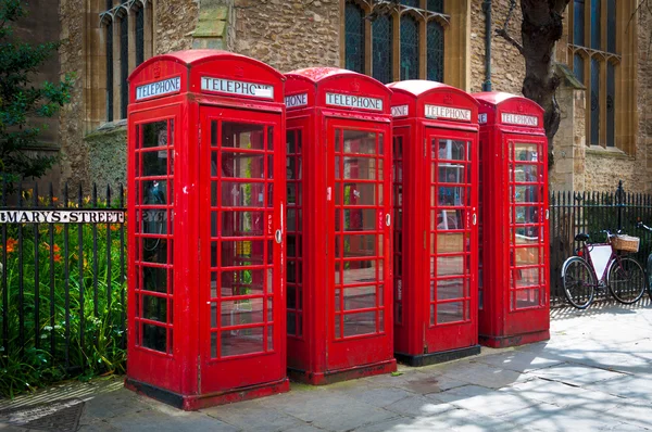 Row of vintage british red BT telephone boxes