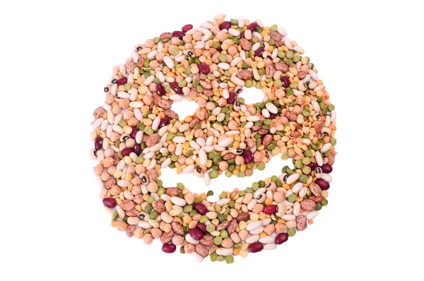 Mixture of dried lentils, peas, soybeans, legumes, beans isolated on white. Smile face made from mixture of legumes