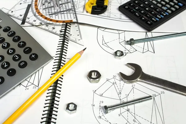 Calculator and measuring equipment with nuts on technical drawing