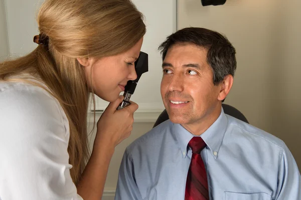 Eye Doctor Examining Hispanic Patient