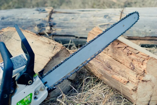 Close up chain saw on log