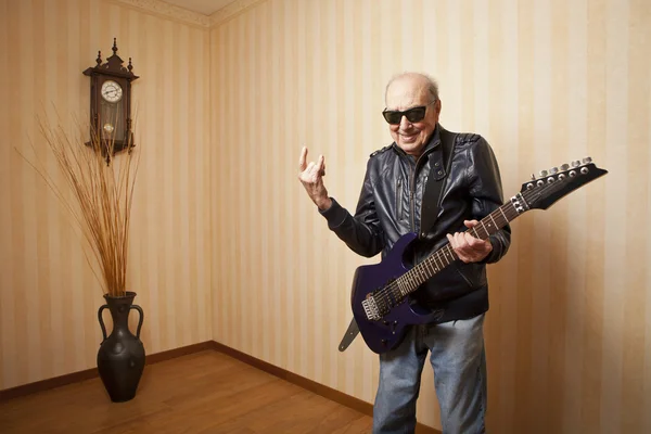 Cool fashion elder man with electric guitar