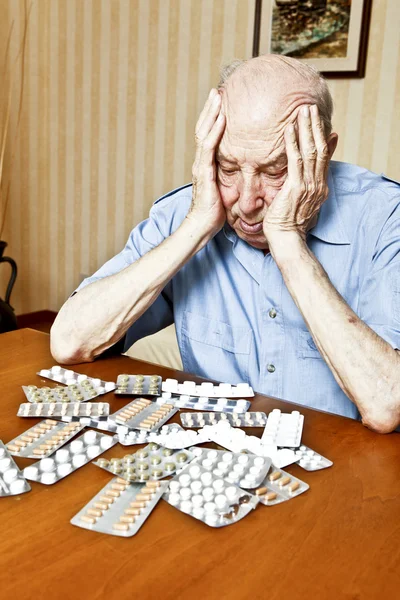 Elder man with pills