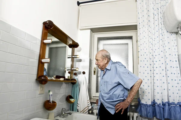 Portrait of elder man in the bathroom