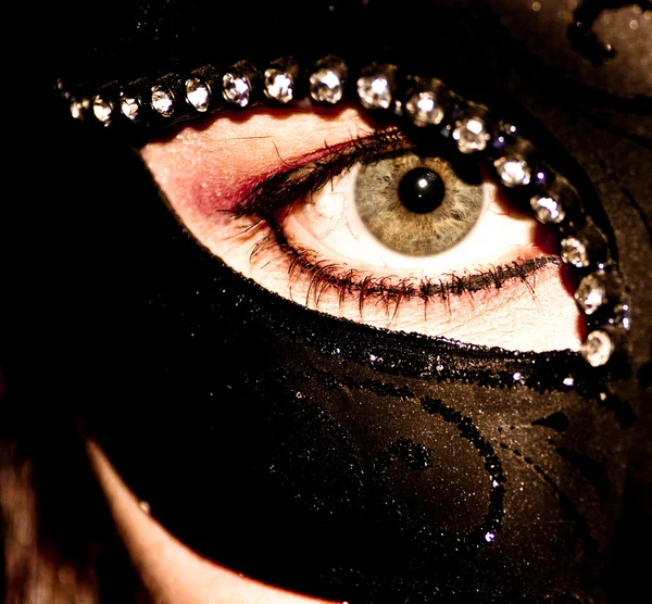 Beautiful young woman wearing dark mask
