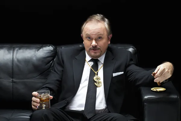 Handsome mafia boss drinking and smoking