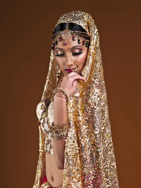 Beautiful young woman in indian bridal dress