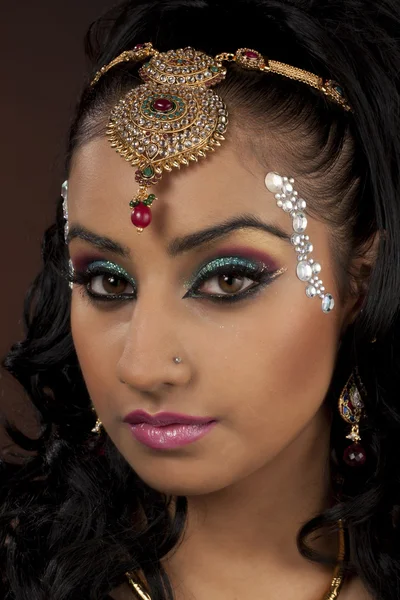 Portrait of a attractive young female with make up and jewel