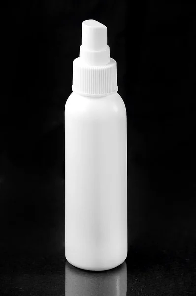 White perfume hair spray cosmetic scented water bottle isolated on black background