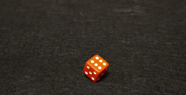 Dice on a black gaming table with space for text