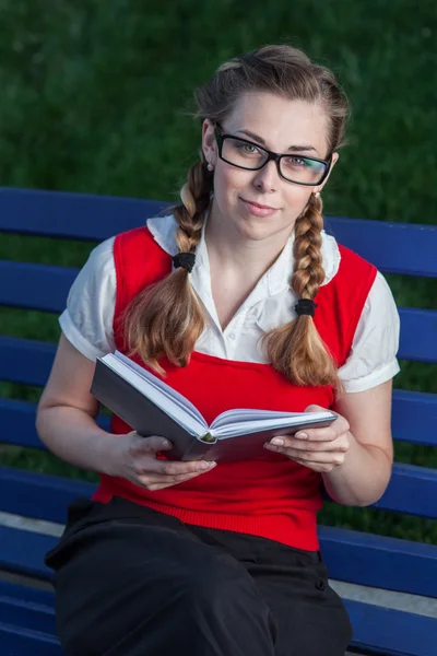 Girl student in park with flowers