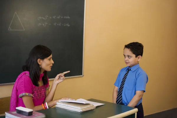 Teacher scolding a student