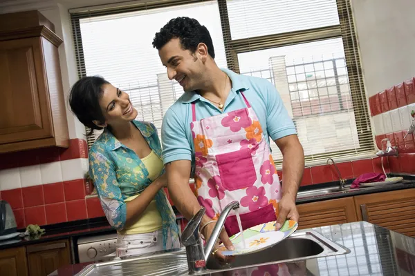 Couple washing dishes
