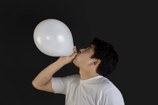 Man blowing balloon