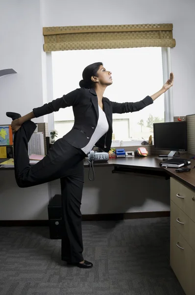 Business executive in a yoga position