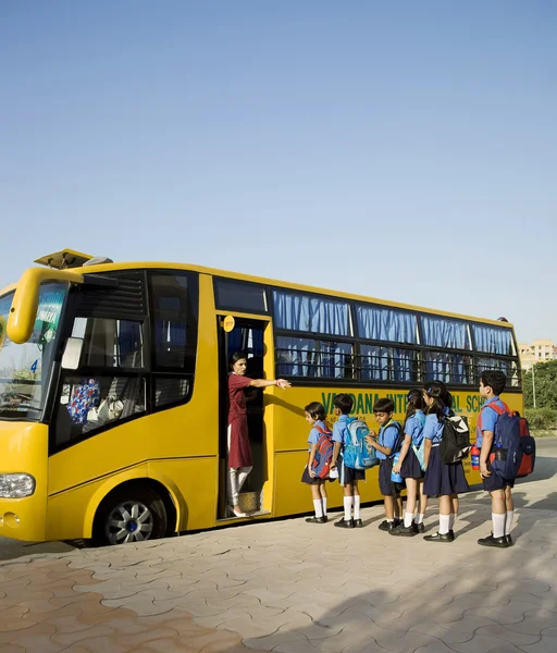 School children getting onto a school bus - 