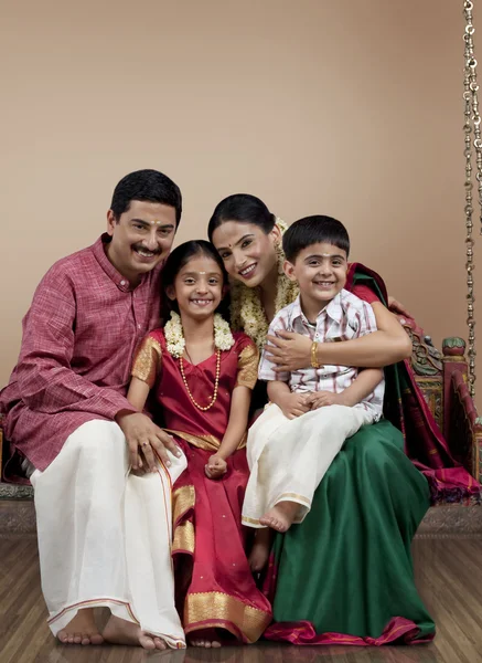 South Indian family sitting on a jhula