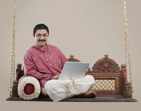 South Indian man with a laptop