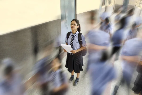 Students walking past a school girl