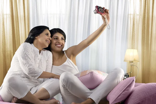 Girl taking a picture of herself and her mother