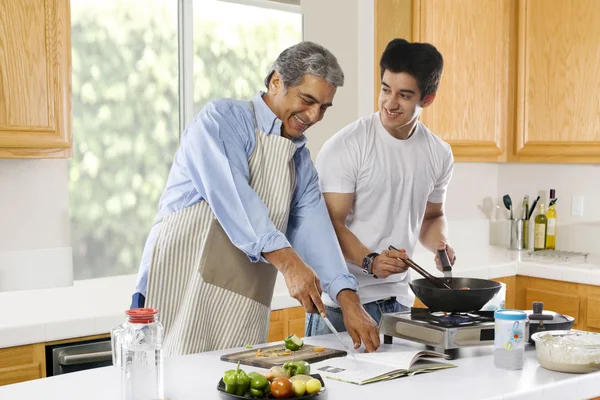 Father and son cooking food