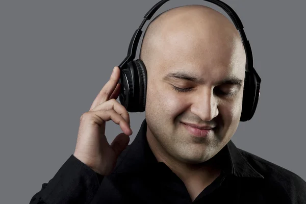 Bald man listening to music