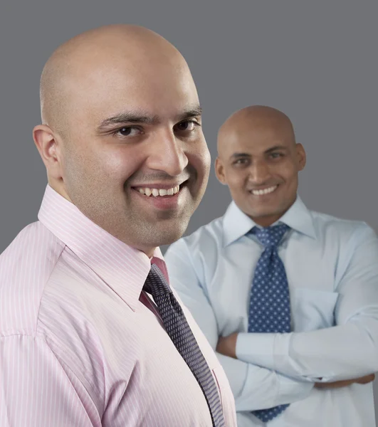 Two bald executives