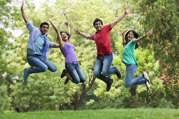 Young college students jumping