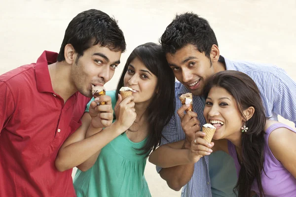 Happy friends holding ice cream