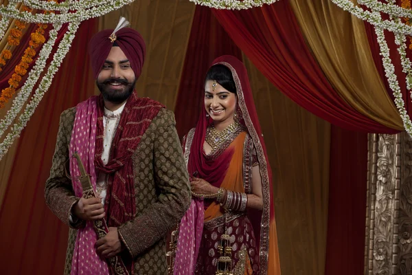 Sikh bride and groom on indian wedding ceremony