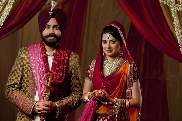 Sikh bride and groom on indian wedding ceremony