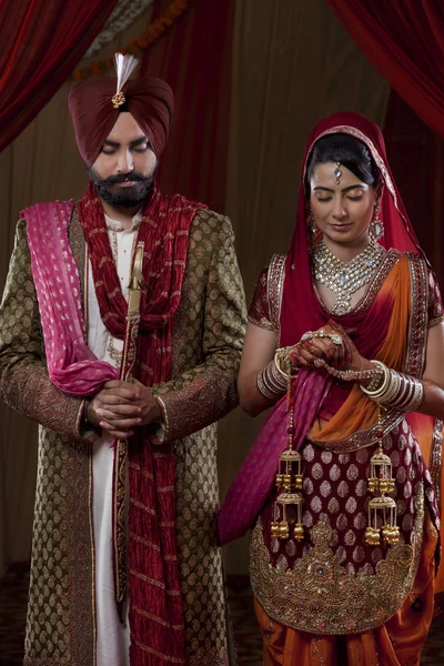 Sikh bride and groom on indian wedding ceremony