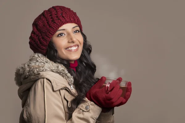 Woman in warm clothes holding tea cup