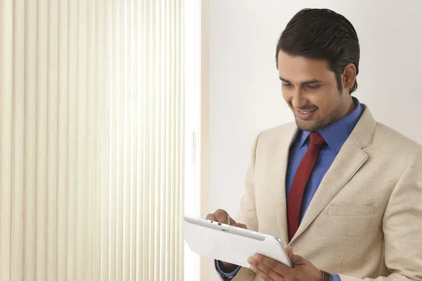 Indian businessman using tablet computer