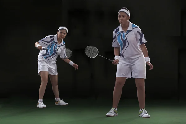 Young women playing badminton