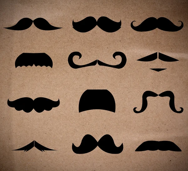 Set of mustaches isolated on recycle paper background.