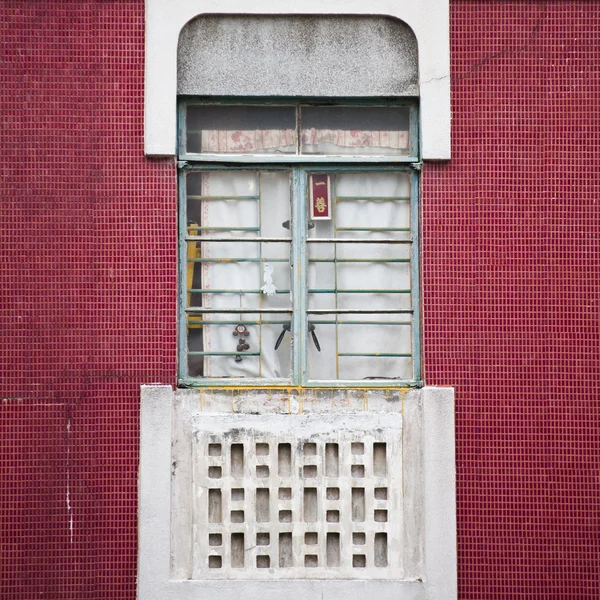 Chinese window on red tile wall