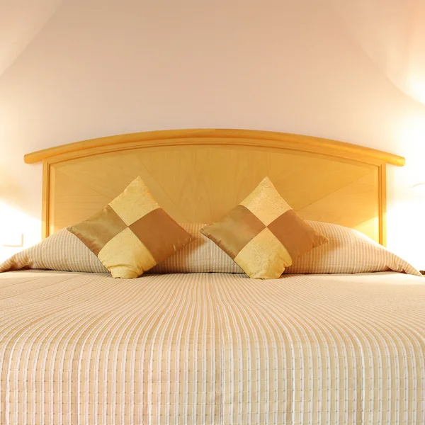 Bed in a hotel room at night — Stock Photo #26431765