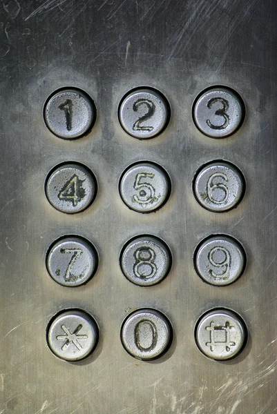 Close up image of a public pay phone keypad